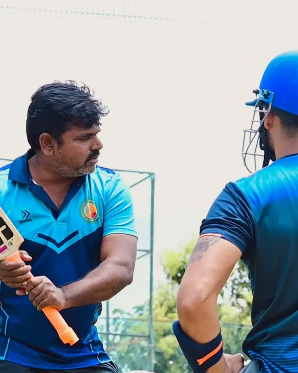 Our coaches, like Vijay Madyalkar, provide hands-on guidance to players at every level. Here, he demonstrates the correct bat grip and stance to a student.
