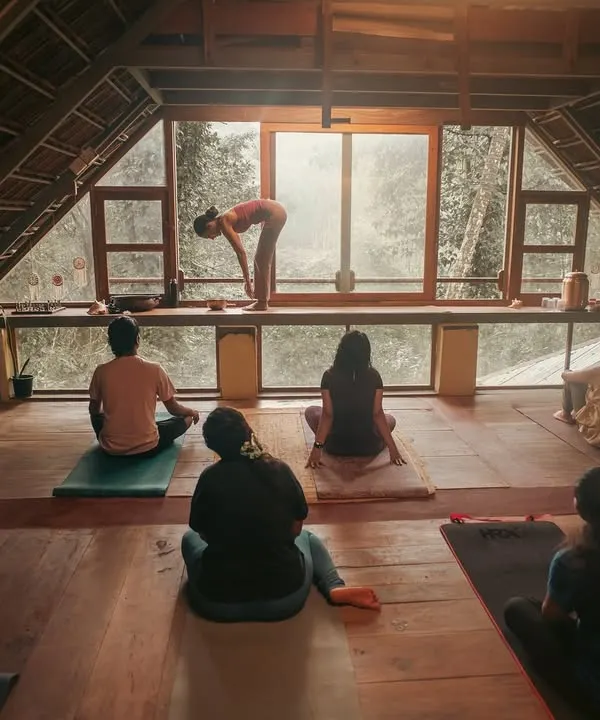 I guide participants through a morning asana practice, held in a beautiful attic space filled with soft, natural light. This is a moment to tune into the body's wisdom, moving with breath and intention, far from the noise of the outside world.