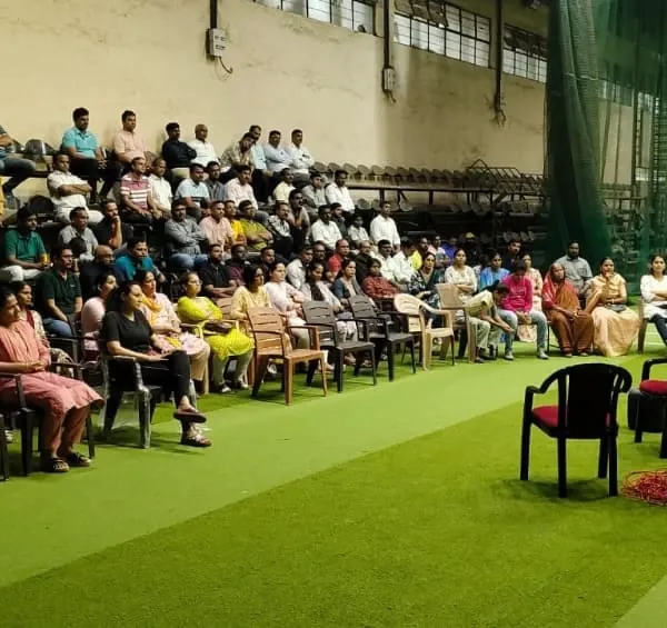 A coach addresses a large gathering of parents at our academy. These meetings are essential for communicating our rules, regulations, and the philosophy behind our training program.
