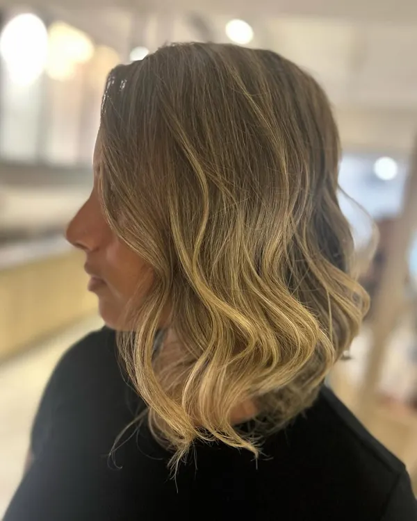 This is the ultimate beach blonde hair. I created this bright, dimensional blonde balayage and styled it with beach waves for a perfect summer look.