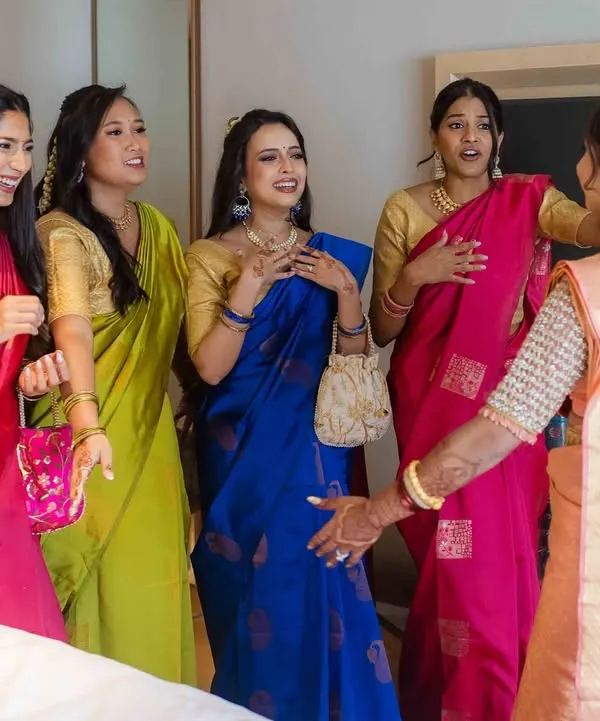 The priceless reaction of the bridesmaids seeing the bride in her wedding dress for the first time. A moment of awe and happiness.