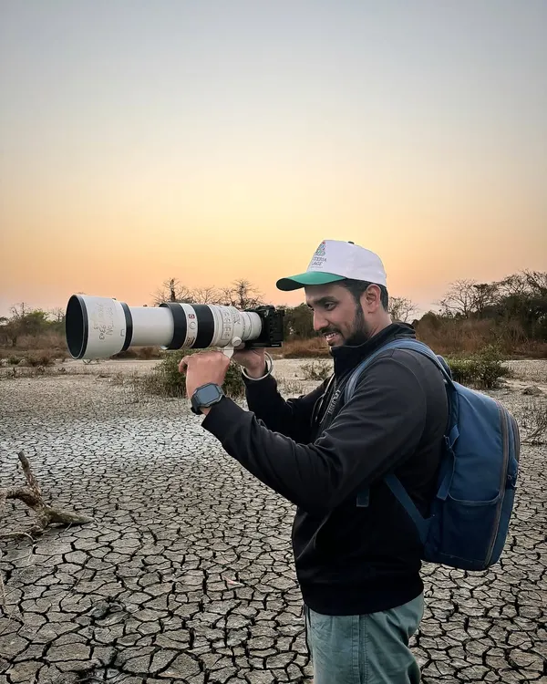 On location for a wildlife shoot, equipped with a telephoto lens. My passion for different types of photography, like birding, sharpens my technical skills and patience, which I bring to every wedding.