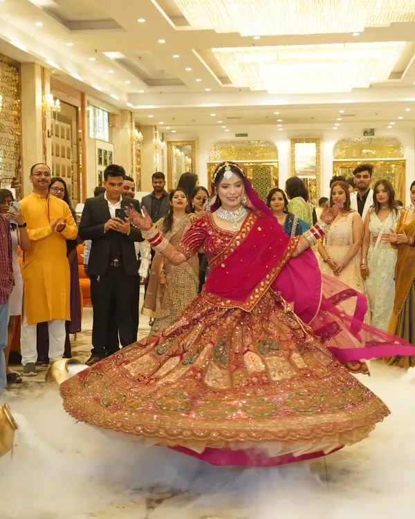This is the kind of moment I live to capture. A beautiful bride, lost in the joy of her wedding day, twirling in her magnificent lehenga amidst a cloud of smoke. It’s pure magic and a perfect shot for your wedding album.