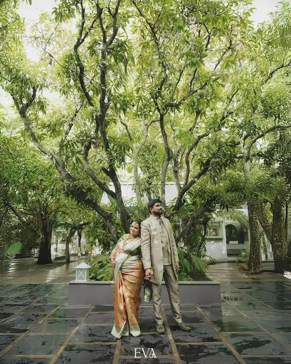 A grand, cinematic portrait of an expecting couple standing together under the canopy of a magnificent tree. This image captures the blend of romance and anticipation that defines our approach to maternity photography.
