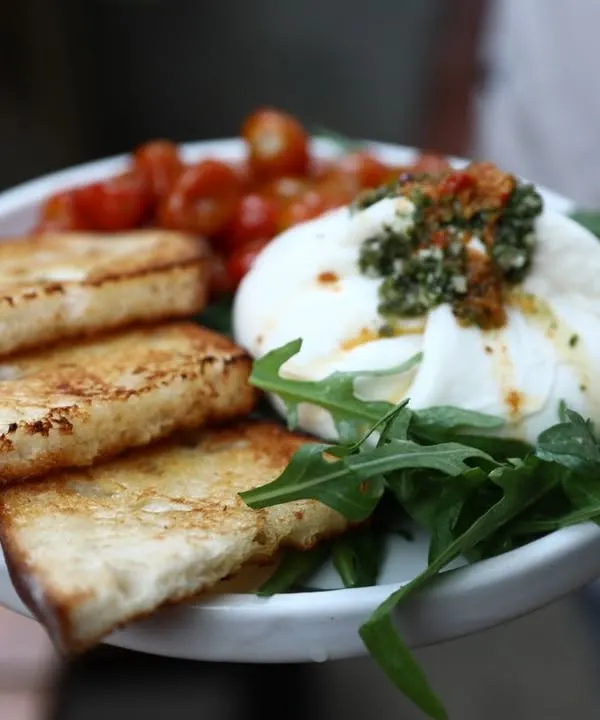 Our house-made burrata served with toasted sourdough bread and sweet, roasted cherry tomatoes. It's simple, fresh, and incredibly delicious.