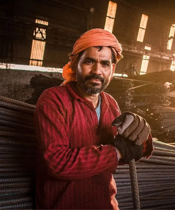 I found this worker during the golden hour at a local steel yard. The way the setting sun lit up the dust and metal was incredible, and I wanted to capture the strength and dignity in his expression. This is the kind of environmental portrait I love to create.