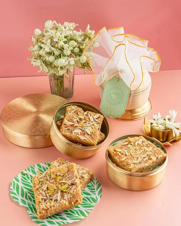 A glimpse into the world we craft through our lens. This shot, styled and photographed by us, showcases premium Indian sweets in elegant brass containers, creating a feeling of luxury and tradition.