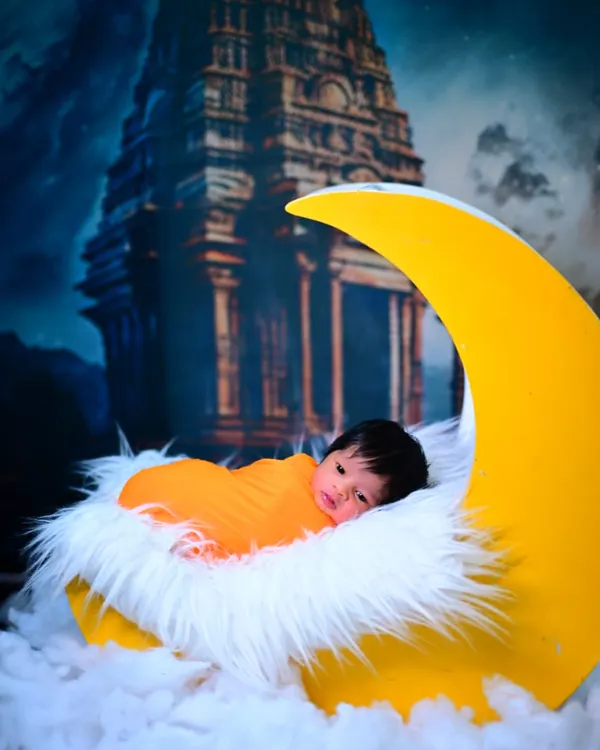 A dreamy newborn photoshoot featuring your little one on a crescent moon prop, set against a magical temple backdrop. I create fantasy scenes to make your baby's first photos truly special.