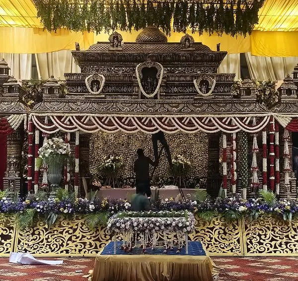 A masterpiece of traditional craftsmanship. This temple-style mandap is being prepared by our team, showcasing the intricate details and dedication that go into creating a truly divine setting for a wedding ceremony.