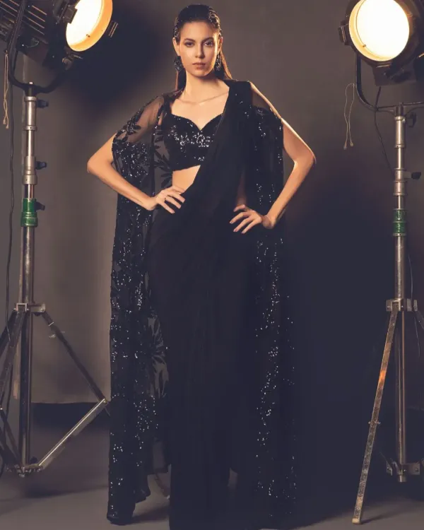Elegance meets tradition with a modern twist. A model poses in a stunning black cape saree, a highlight from one of my recent collections.