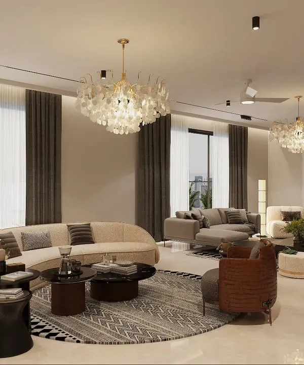 This expansive living room is designed with multiple seating zones to accommodate both large gatherings and intimate conversations. The curved sofa and shell chandeliers add a soft, organic touch to the modern space, while large windows ensure ample natural light.