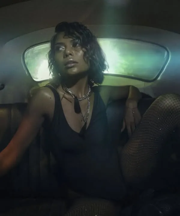 An editorial shot for Twisted Heads Magazine from inside the car. The model's pose and the dark, atmospheric lighting create a sense of unapologetic style and confidence.