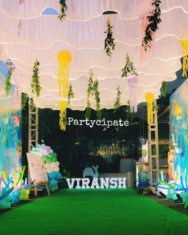 I transformed this walkway into an underwater tunnel for Viransh's first birthday. The walls were covered in a sea-life print, and I hung fabric waves and jellyfish from the ceiling to make guests feel like they were walking on the ocean floor.