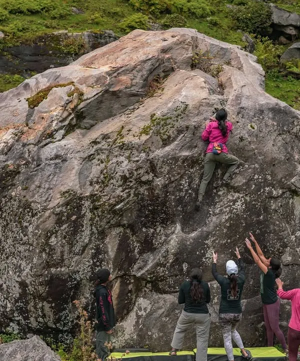A climber takes on a massive boulder during our Sethan retreat. The scale of the landscape is matched only by the determination of our community, with everyone spotting and supporting from below.