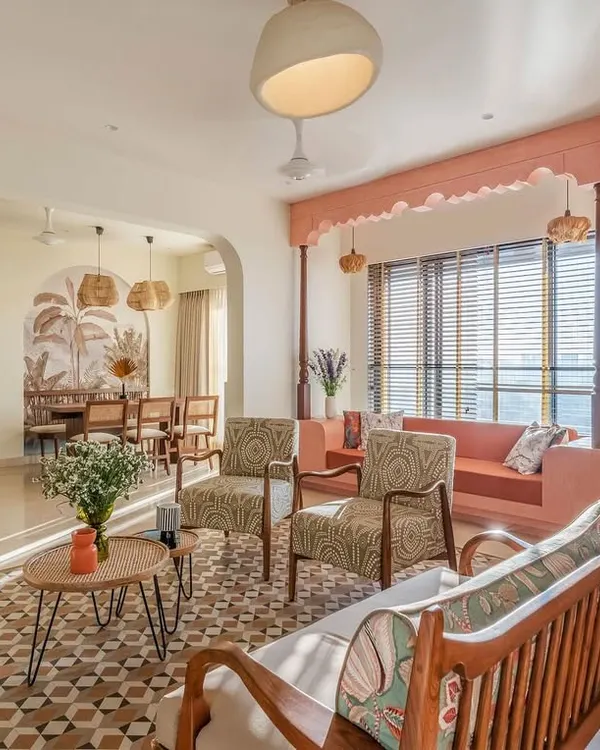 This sunlit living room captures the essence of a tranquil, traditional Mumbai home. We designed the space to feel open and connected, using custom cane partitions to gently define the area while maintaining a sense of flow. The terracotta-colored swing sofa and patterned floor tiles add warmth and a touch of heritage.