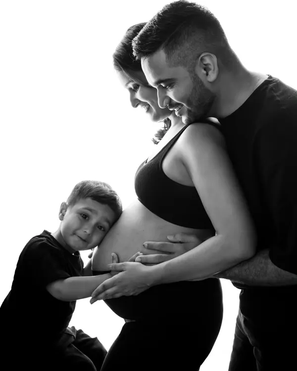 This is what it's all about. A beautiful black and white family portrait with the soon-to-be big brother giving the baby bump a hug. You can feel the love and excitement from everyone.
