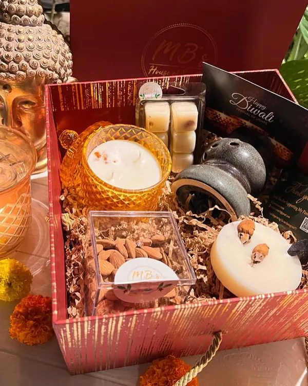 This is my signature 'Box of Scents', curated for Diwali. It’s filled with fragrant treasures like a three-wick soy candle, a ceramic diffuser with wax melts, an aroma tablet, and a box of almonds, all ready to bring light and warmth to your celebrations.