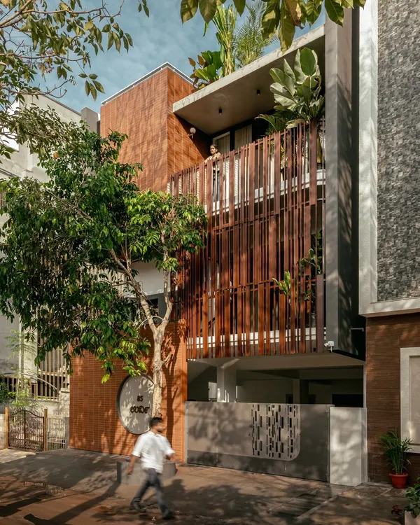 This is the 'Ittige' residence, a project that embodies our tropical contemporary style. We designed the structure to coexist with the surrounding landscape, using the vertical louvered facade and brickwork to create a dialogue between the built form and the natural environment, making the home feel like a part of the garden itself.