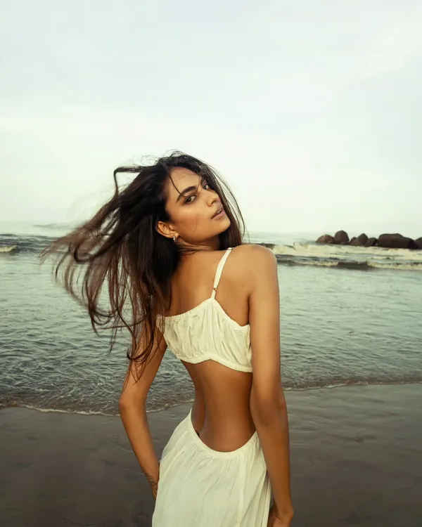 A candid, windswept moment from a beach editorial. I used the natural, late-afternoon light to capture the movement of her hair and the soft texture of the dress.