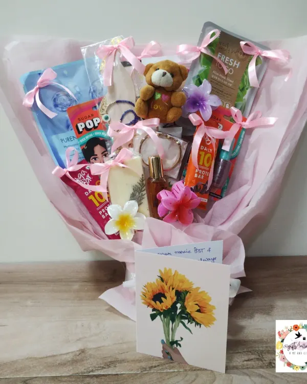 A gift bouquet I designed for actress Helly Shah in a pink theme. Instead of flowers, this bouquet is filled with small gifts like skincare items, a teddy bear, and protein bars.