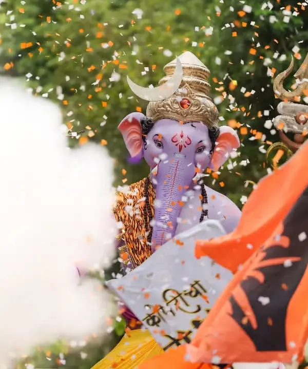 A dynamic shot of Kopri Cha Samrat, using smoke and confetti to create a festive and energetic atmosphere during the procession.