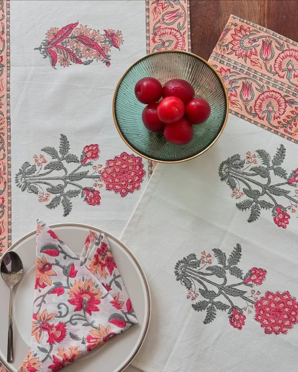 This is what a thoughtfully laid table looks like. My block-printed cotton table linen set, featuring a runner and matching napkins, brings artisanal charm to any meal. The soft peach and floral designs are perfect for festive feasts or simply making a Tuesday dinner feel more special.