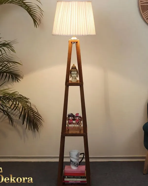 This dark wood finish shelf lamp offers a sophisticated alternative for your living space. The integrated shelves are perfect for displaying small plants or decor, while the pleated shade casts a soft, inviting glow.