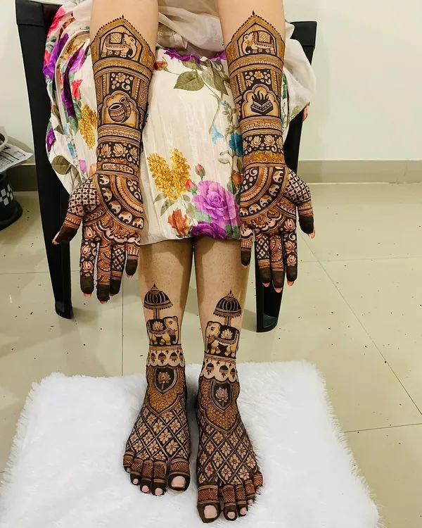 A complete bridal mehndi set for a truly royal look. This design covers both hands and feet with coordinated patterns, featuring traditional elephant motifs, intricate jaal work, and auspicious symbols for a cohesive and stunning bridal look.