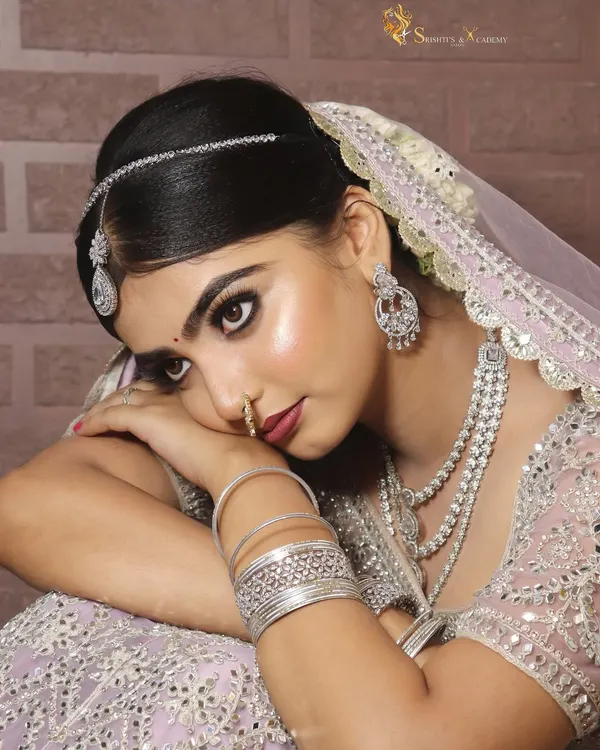 Soft bridal glam at its finest. This beautiful pastel lehenga is paired with a dewy, luminous makeup look, featuring a subtle smokey eye and a soft pink lip for a modern and romantic feel.