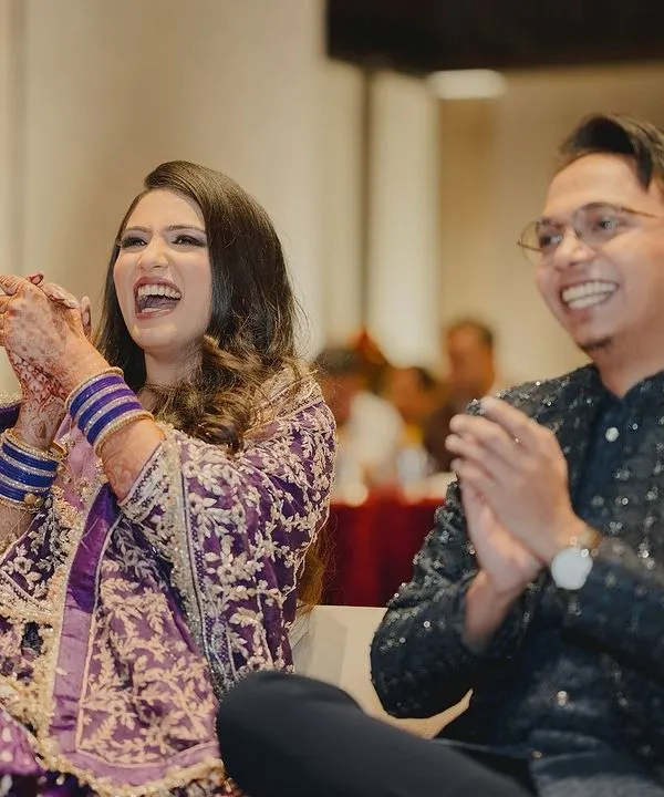 The best reward is seeing the bride and groom laughing and enjoying the performances. This candid shot captures the pure joy of a successful sangeet night.