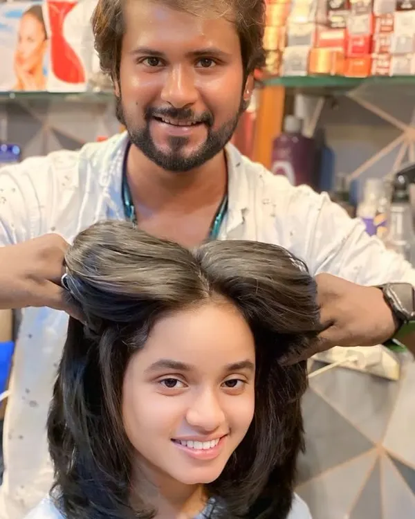 Here I am adding the final touches to a voluminous, layered haircut. You can see how the layers create a full, bouncy shape, even before the final styling.