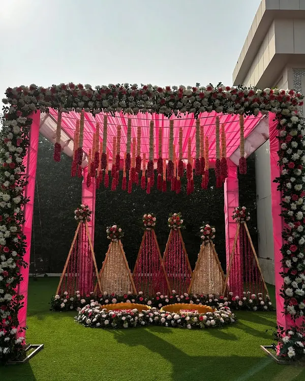 We believe every ceremony should reflect your personality. For this Haldi, we moved away from traditional yellow and created a dreamy setup using shades of pink, complete with a stunning floral mandap and hanging tuberoses.