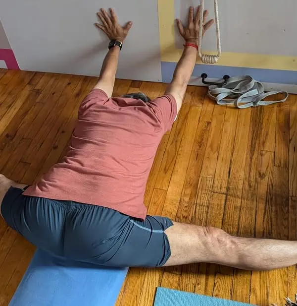 A deep expression of Upavistha Konasana (Wide-Angle Seated Forward Bend) using the wall for support to deepen the stretch in the hamstrings and inner thighs.