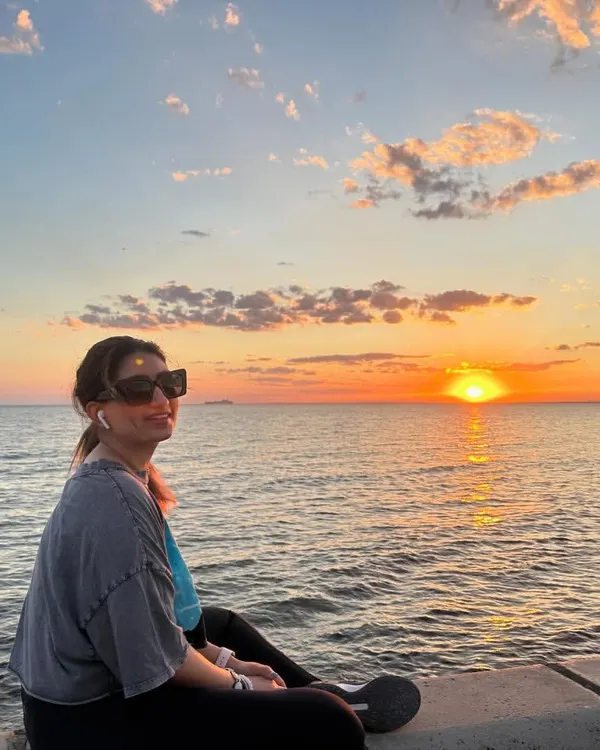 Enjoying a magical sunset over the ocean. There is something so calming about watching the sun dip below the horizon, and it's a perfect time for quiet reflection.