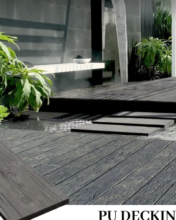 This poolside area features my dark grey PU decking. The material is slip-resistant and waterproof, making it a safe and stylish choice for areas around water. The stepping stones appear to float over the deck.