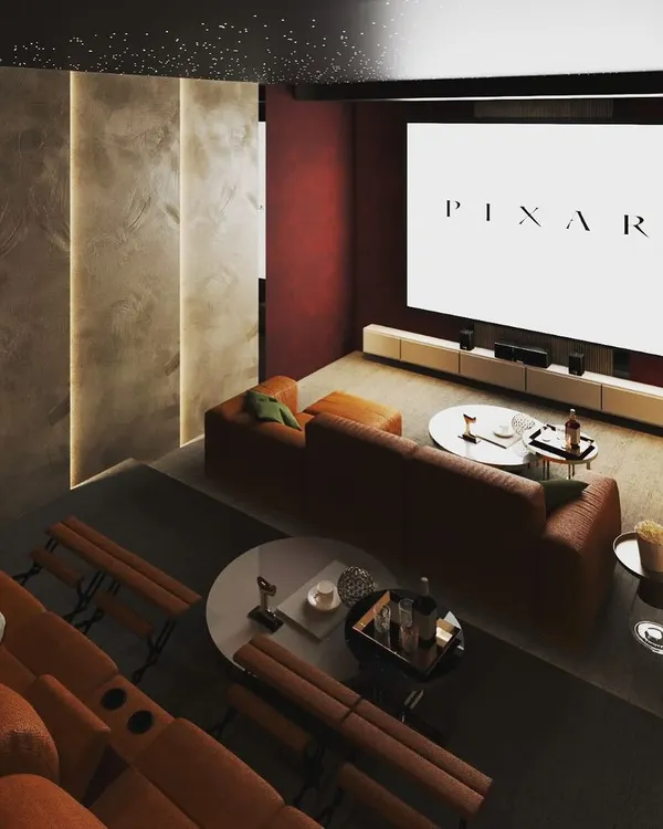 Cozy evenings are best spent in a home theater like this. I designed this space with two-tiered seating, including plush recliners and a comfortable sofa, ensuring everyone has the best seat in the house for movie night.