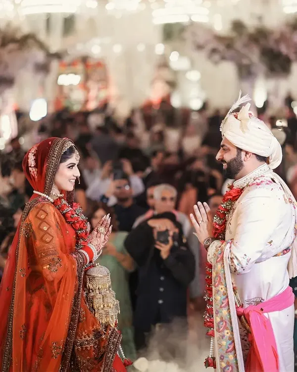 The Jaimala ceremony, a moment of joy, anticipation, and gentle teasing. I capture this pivotal moment with a focus on the couple's expressions and the energy of the crowd.