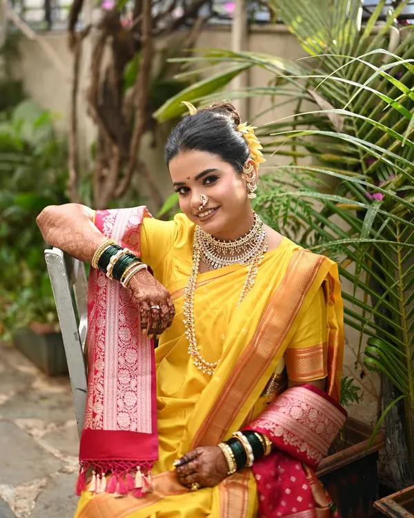 This is the look that captures the heart of Maharashtrian tradition. A perfectly draped yellow Nauvari, soft glam makeup that enhances her natural beauty, and a traditional khopa hairstyle create a look that is both regal and timeless.