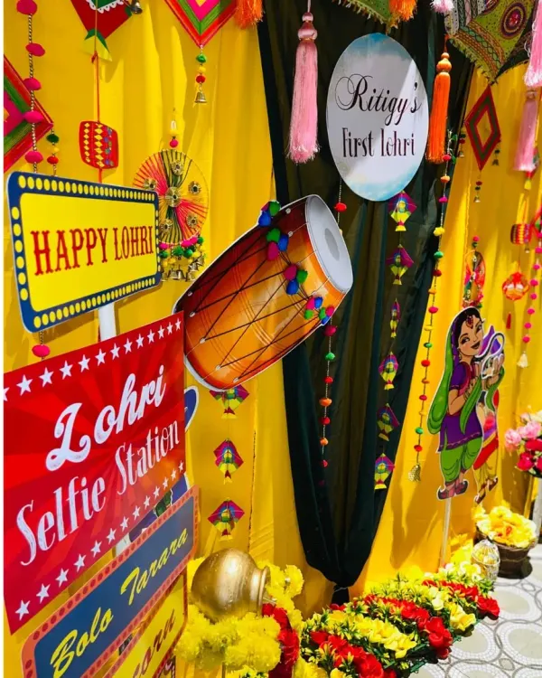 A closer look at the Lohri selfie station. I used fun signs, dhol cutouts, and traditional hangings against a bright yellow backdrop to create a perfect photo corner.