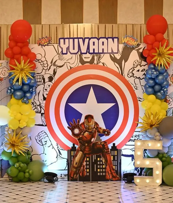 This is what turning five looks like in a superhero universe. I designed this entire Marvel-themed backdrop with a light-up number, life-sized character cutouts, and comic-book graphics to create an epic photo zone for the birthday boy, Yuvaan.