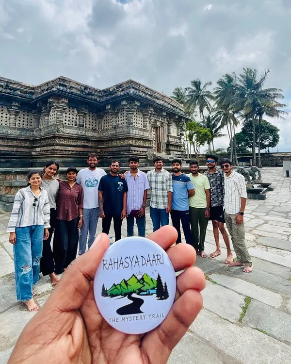 A group posing with my signature badge in front of the stunning Chennakesava Temple in Belur. My cultural tours explore the masterpieces of Hoysala architecture.