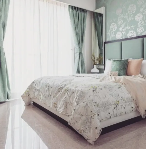 This beautiful bedroom showcases a subtle floral pattern applied in a tone-on-tone mint green. This finish provides a wallpaper-like effect with the durability of paint, adding a touch of classic elegance.