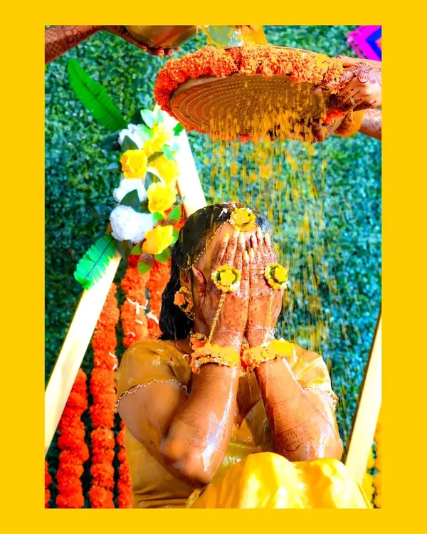 A classic Haldi moment, as the bride is showered with turmeric and flower petals. I capture the joy and tradition of this beautiful pre-wedding ritual.