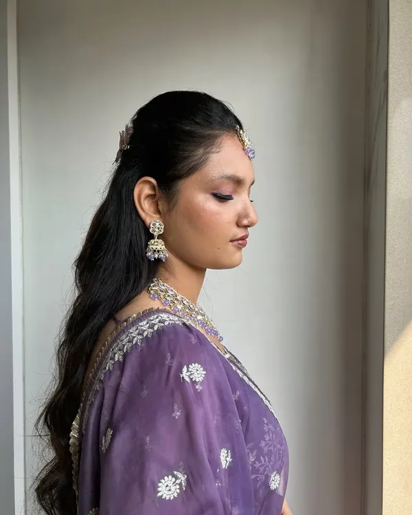 This soft glam look is perfect for a bridesmaid or sister of the bride. The clean, radiant base and pop of purple on the eyes create a fresh and youthful appearance.