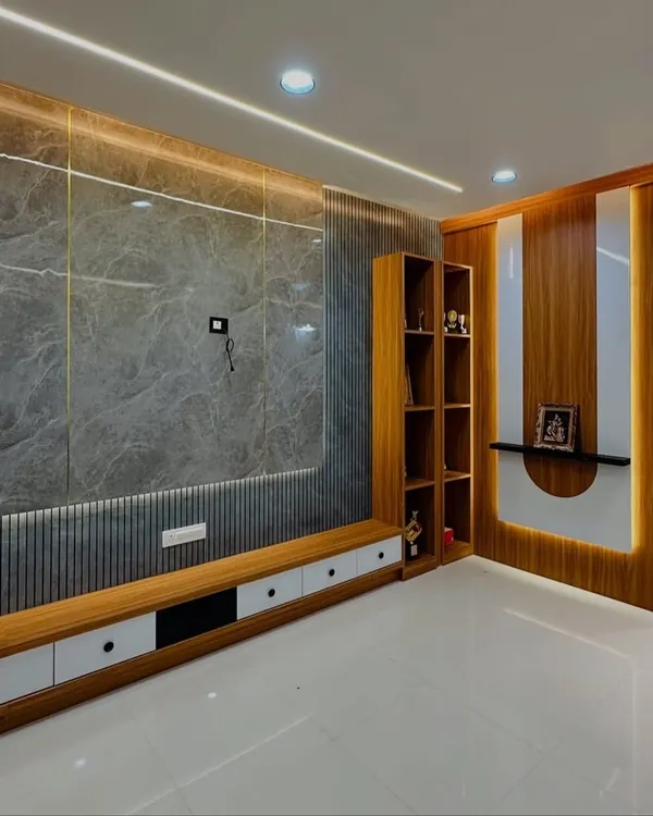 This living room features a floor-to-ceiling entertainment unit combining grey marble, fluted wooden panels, and integrated shelving. The warm backlighting highlights the different textures, creating a sophisticated focal point.