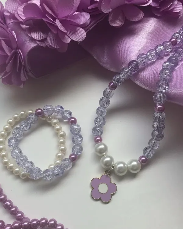 This lavender and purple jewellery set is a favourite among my younger customers, especially fans of BTS. The set, featuring a flower charm necklace and matching bracelets, is styled here with coordinating accessories.
