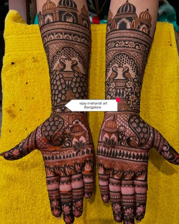 A perfect example of a grand bridal design, with symmetrical palace domes on each arm and facing peacocks. The detail work is extremely fine, creating a rich and dense pattern.