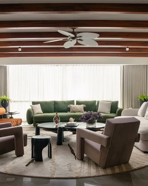 A Parisian-inspired home where every detail is curated to spark joy. This view showcases the blend of sculptural furniture, a soft color palette, and architectural elements like exposed beams and arches to create a life of quality.