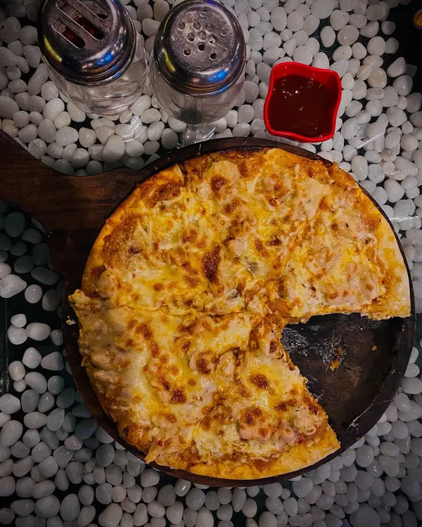 My Alfredo Pizza is pure cheesy goodness on a thin crust. It arrives at your table hot and bubbling, but it never lasts long once everyone grabs a slice.
