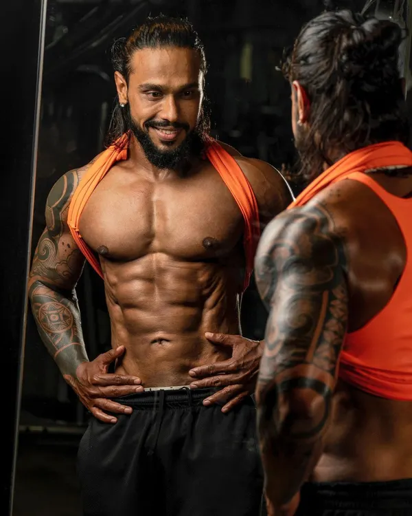 Admiring the progress in the mirror. This is a moment of satisfaction that comes after months of hard work and dedication to the craft of bodybuilding.